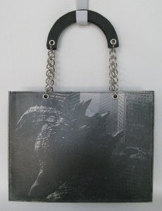 The front and back of this bag are the same image with a matt plastic coating; magnetic snap closure inside the bag.